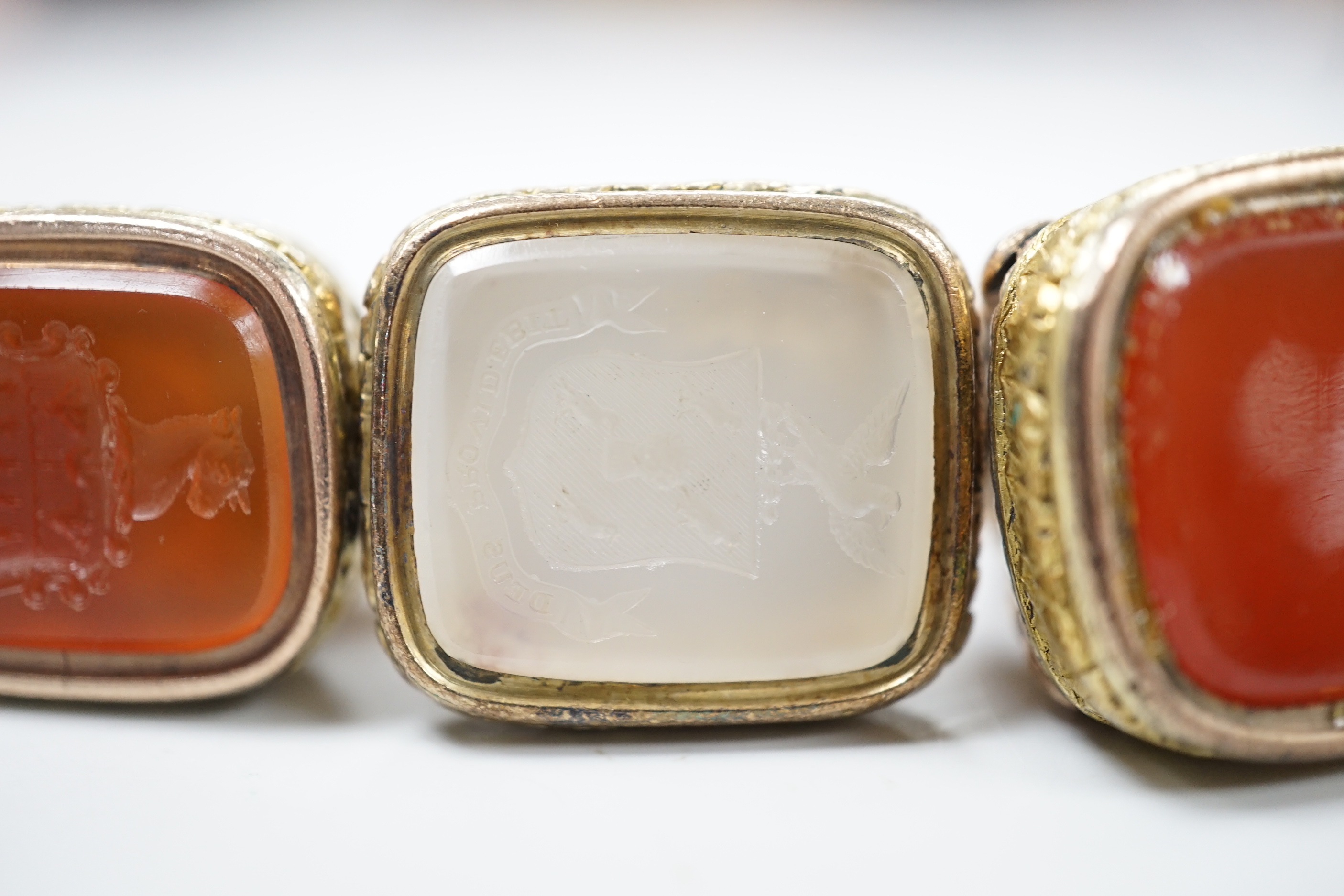 Three assorted Georgian gold plated and chalcedony set fob seals, two with carved matrix, approx. 35mm.